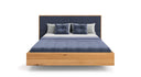 Designer wooden bed Valent made of solid oak in a floating appearance